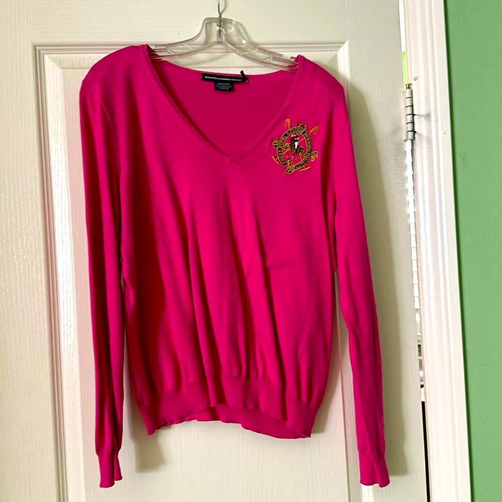 Long sleeve, v-neck magenta shirt with R L logo .Horse is brown,black, gold